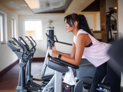 Pretty woman doing physical exercises in gym.